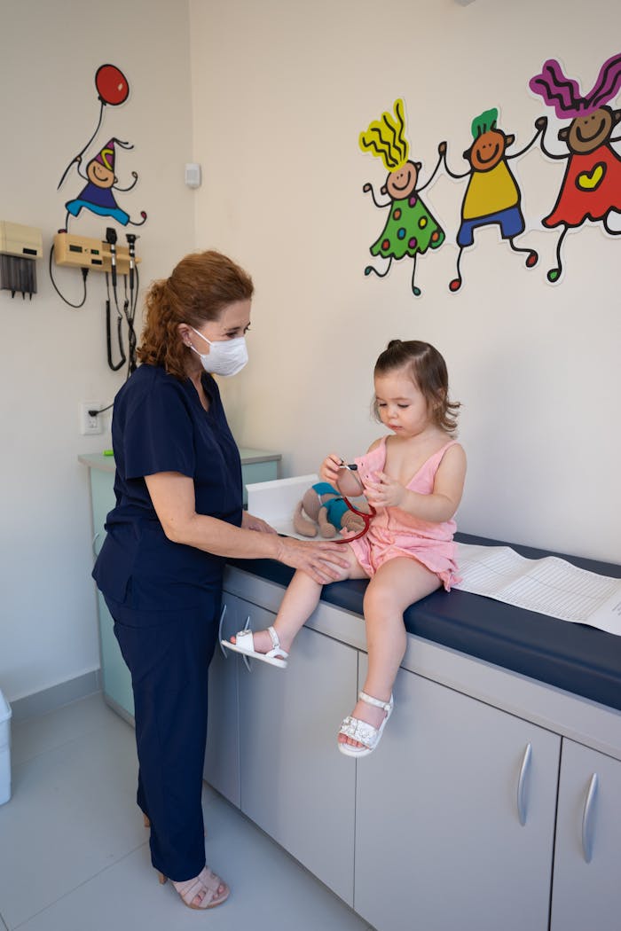 gallery-3 A child is examined by a nurse in a pediatrician's office, emphasizing gentle healthcare.